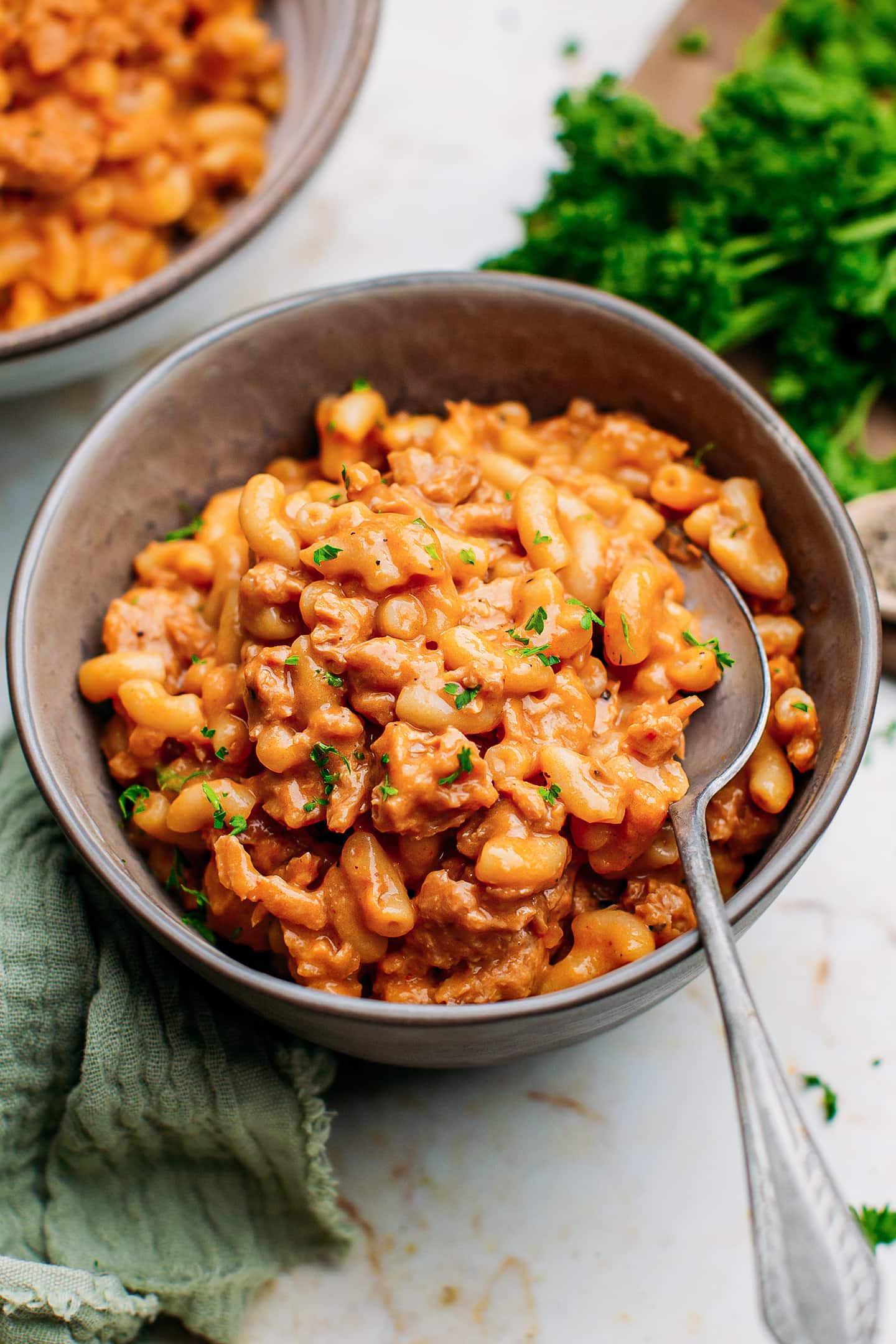 Hamburger helper topped with parsley in a small bowl.