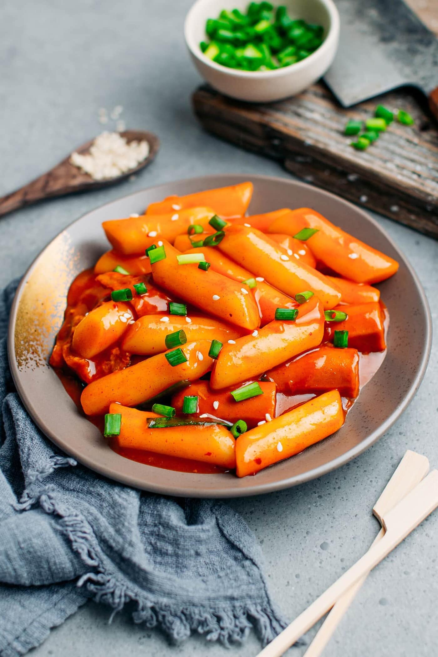 Spicy Korean rice cakes in a bowl with chopsticks.