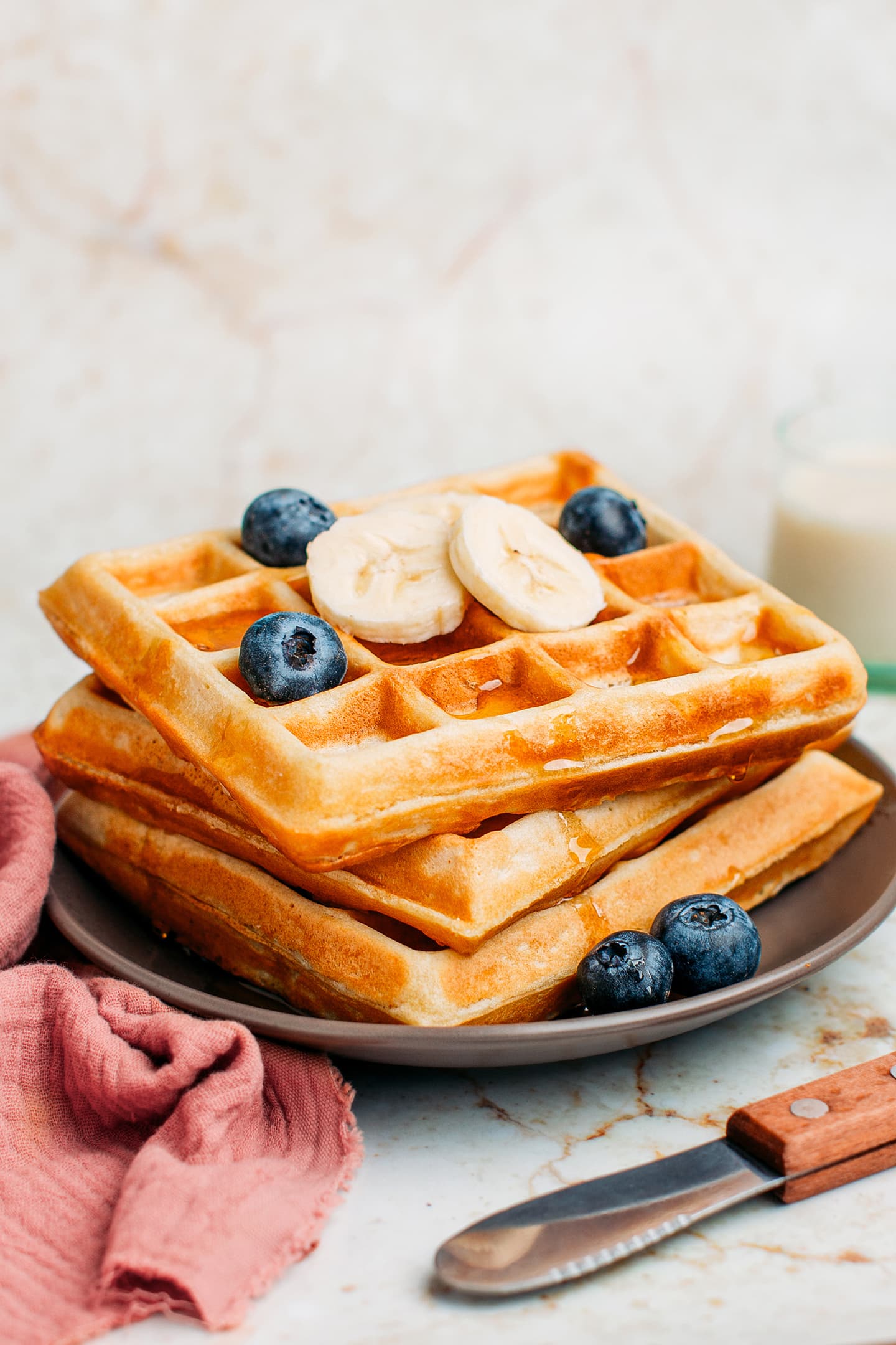 Vegan waffles with blueberries and sliced bananas.