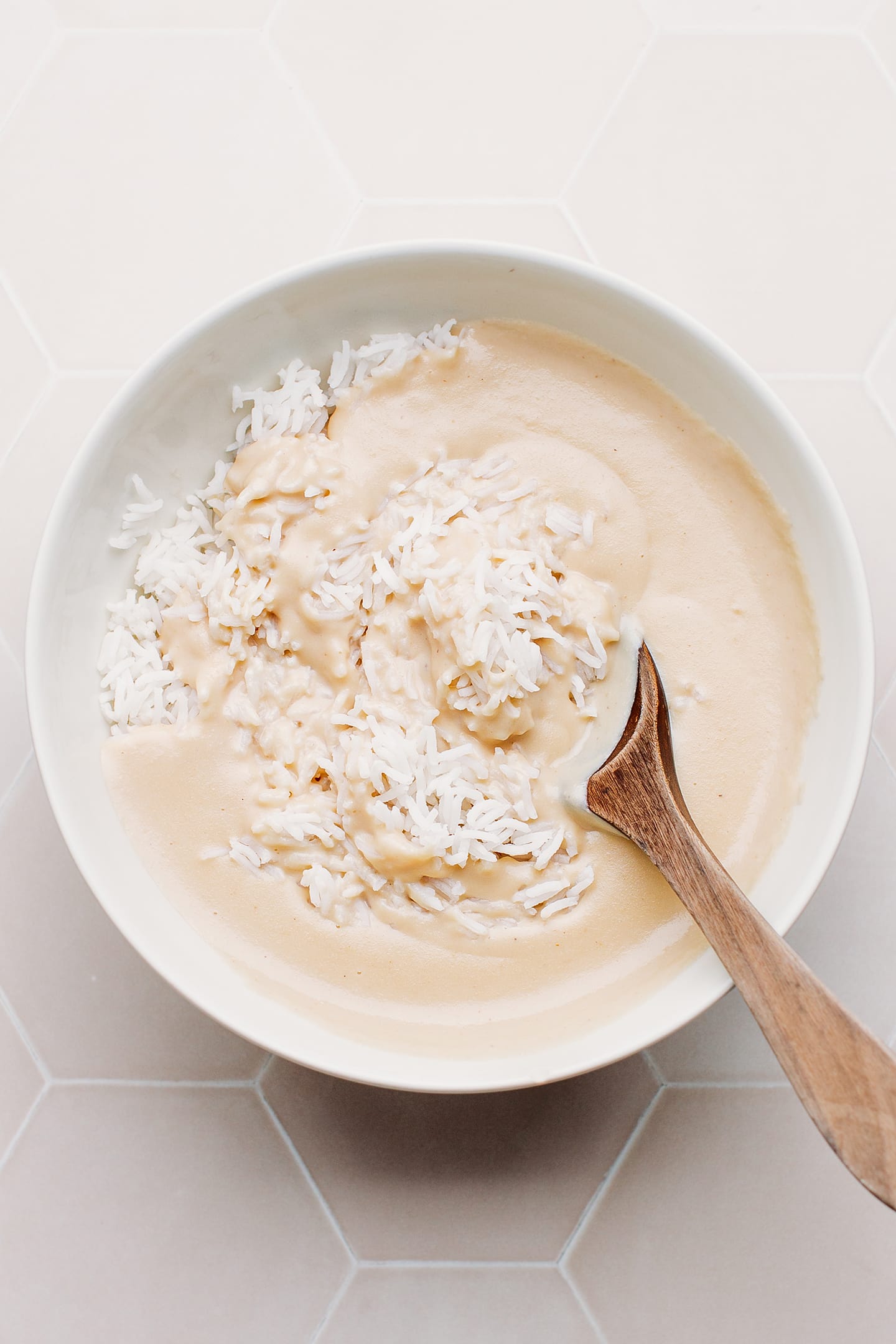 Stirring rice with cheese sauce.