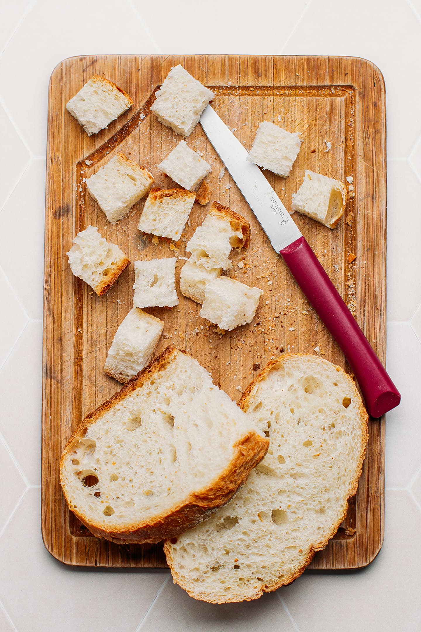 Diced bread on a cutting board.