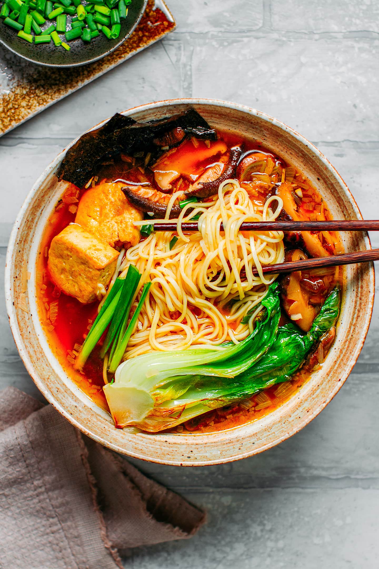 Close-up of vegan ramen with noodles, tofu, mushrooms, and pak choi