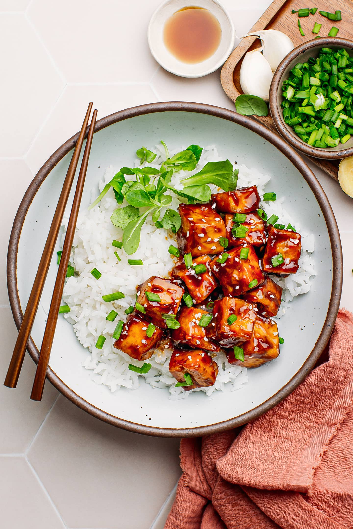 Teriyaki tofu with white rice in a bowl.