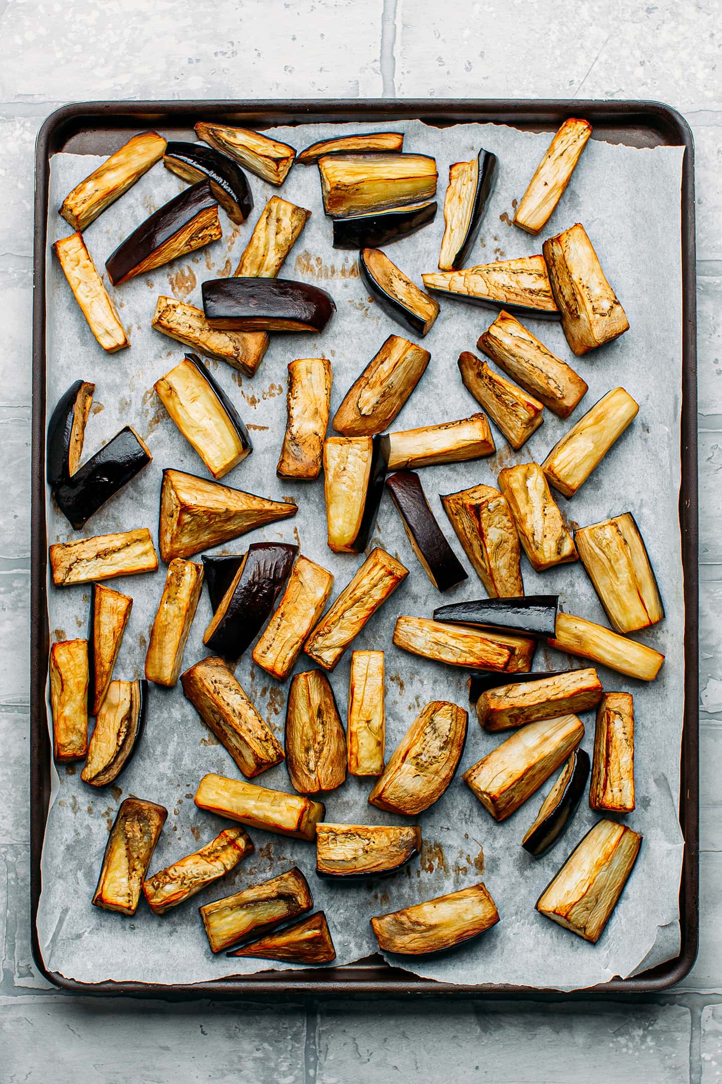 Roasted eggplants on a baking sheet.