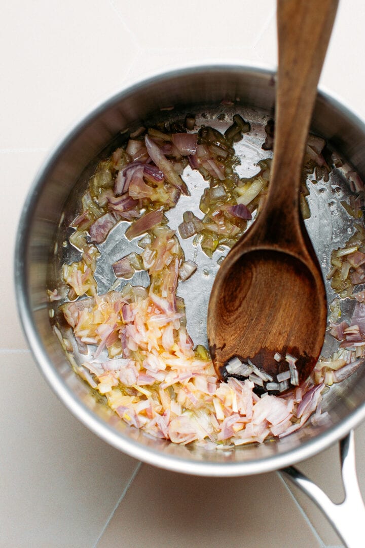 Sautéed shallots in a saucepan.