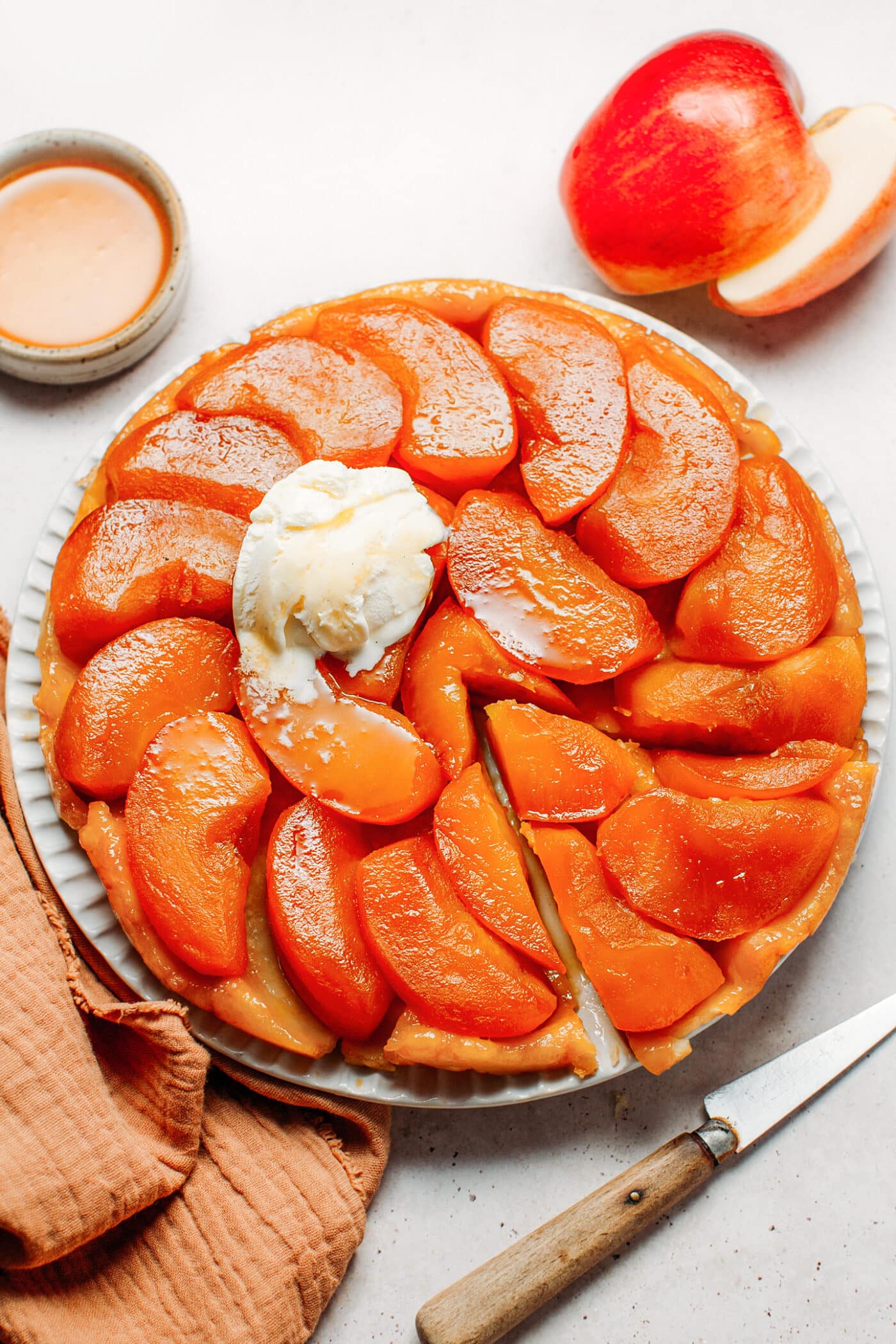 Apple tarte tatin topped with a scoop of vanilla ice cream.