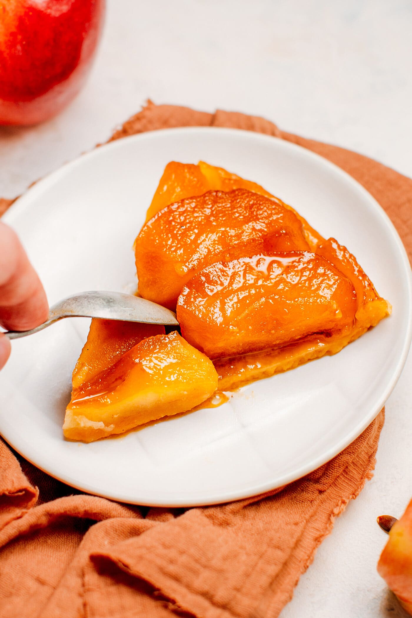 Slice on apple tarte tatin on a plate.