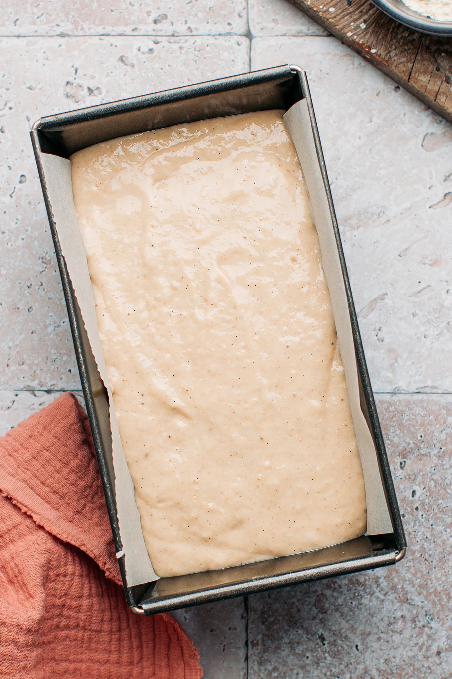 Banana bread batter in a loaf pan.