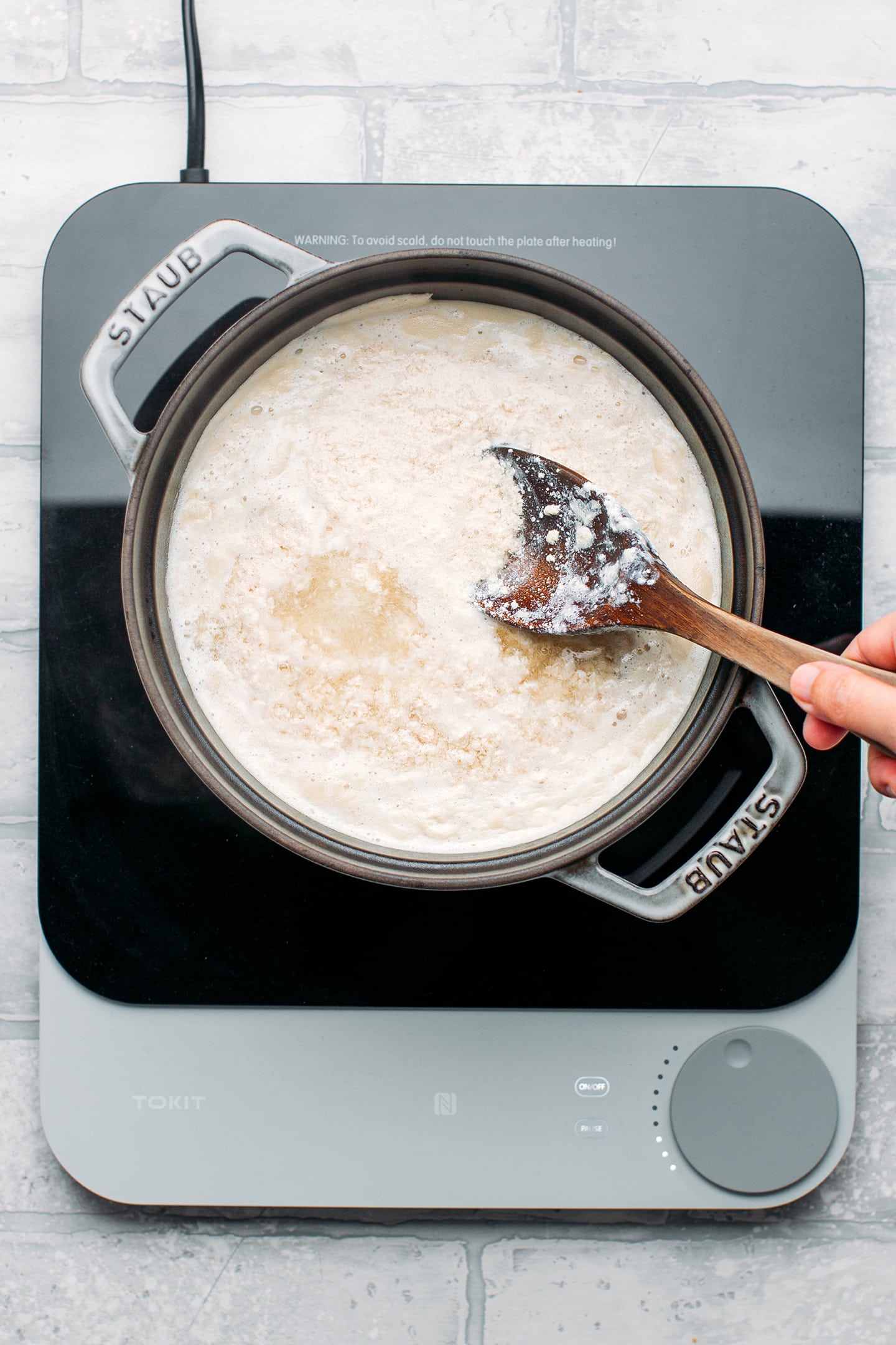 Curdling soy milk in a pot.