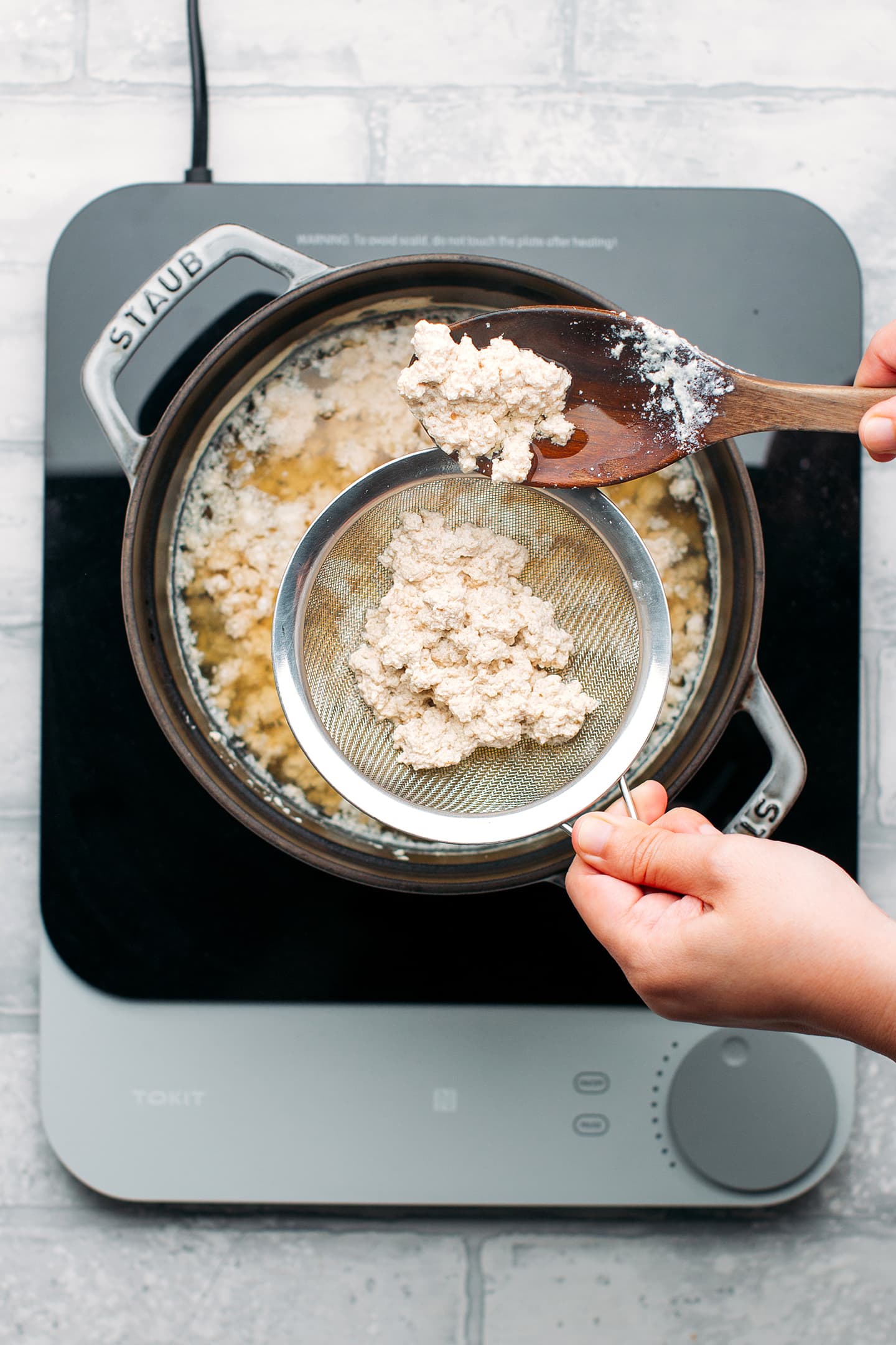 Straining curds from soy milk.