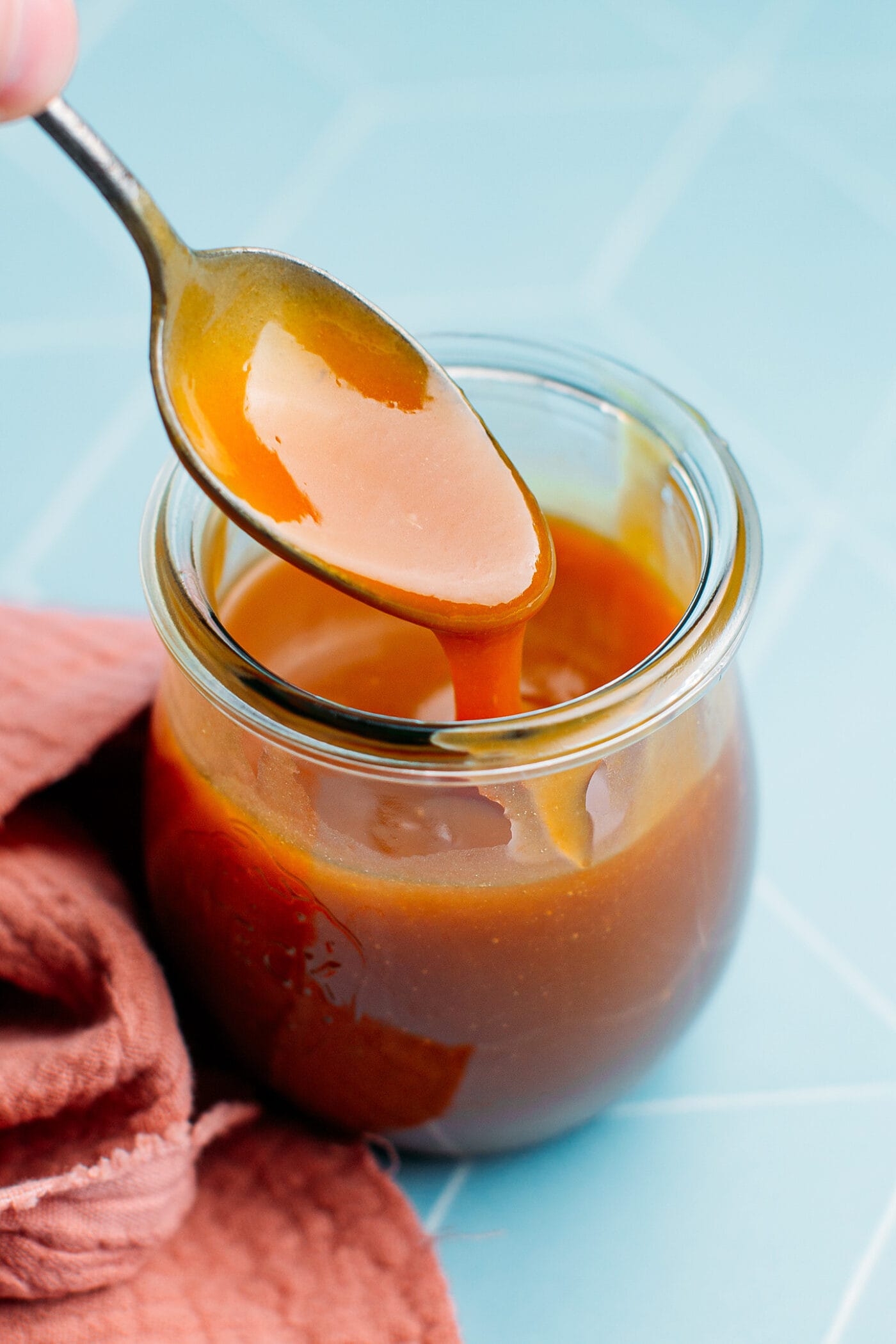 Spoonful of vegan salted caramel sauce.