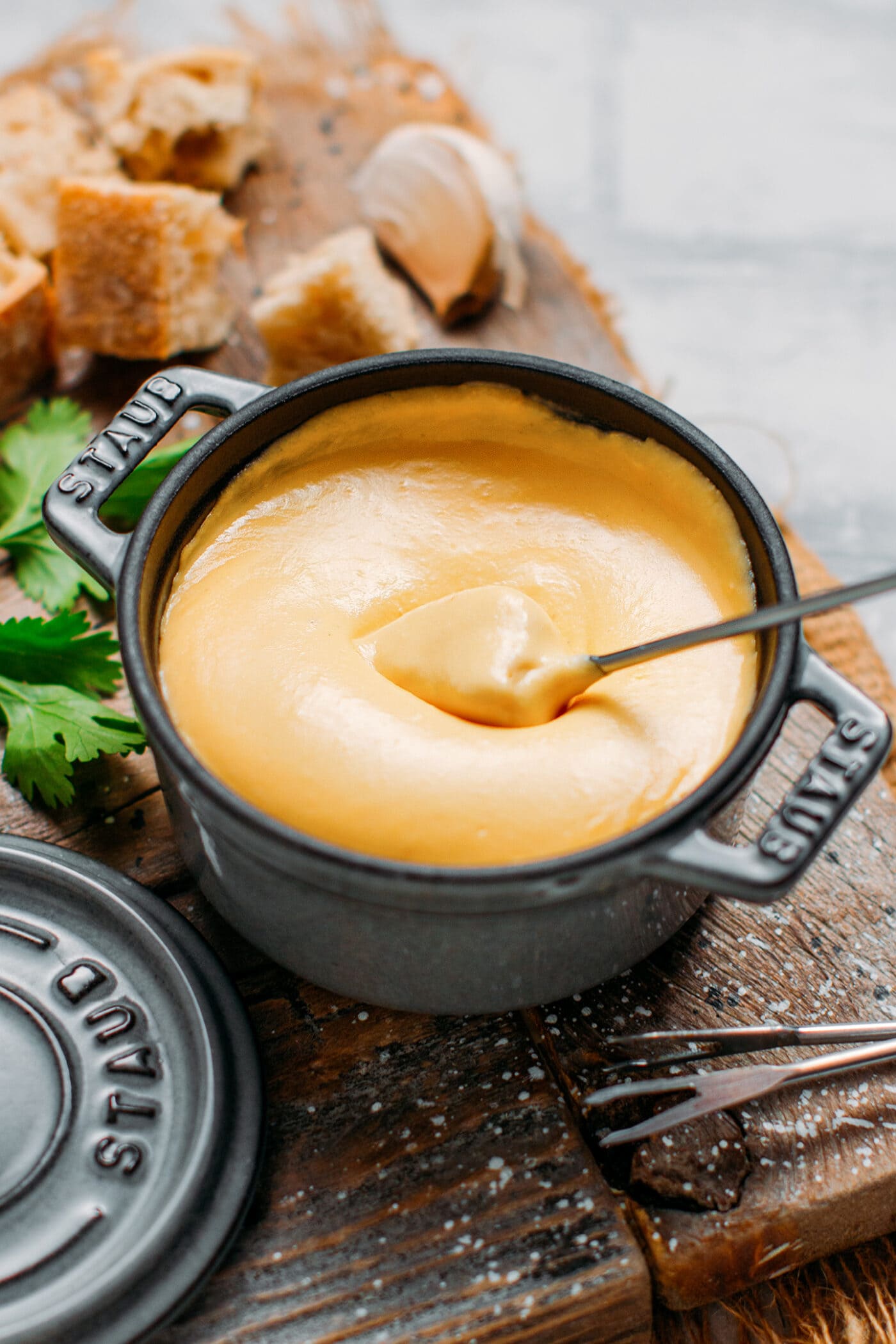 Dipping bread into vegan fondue.