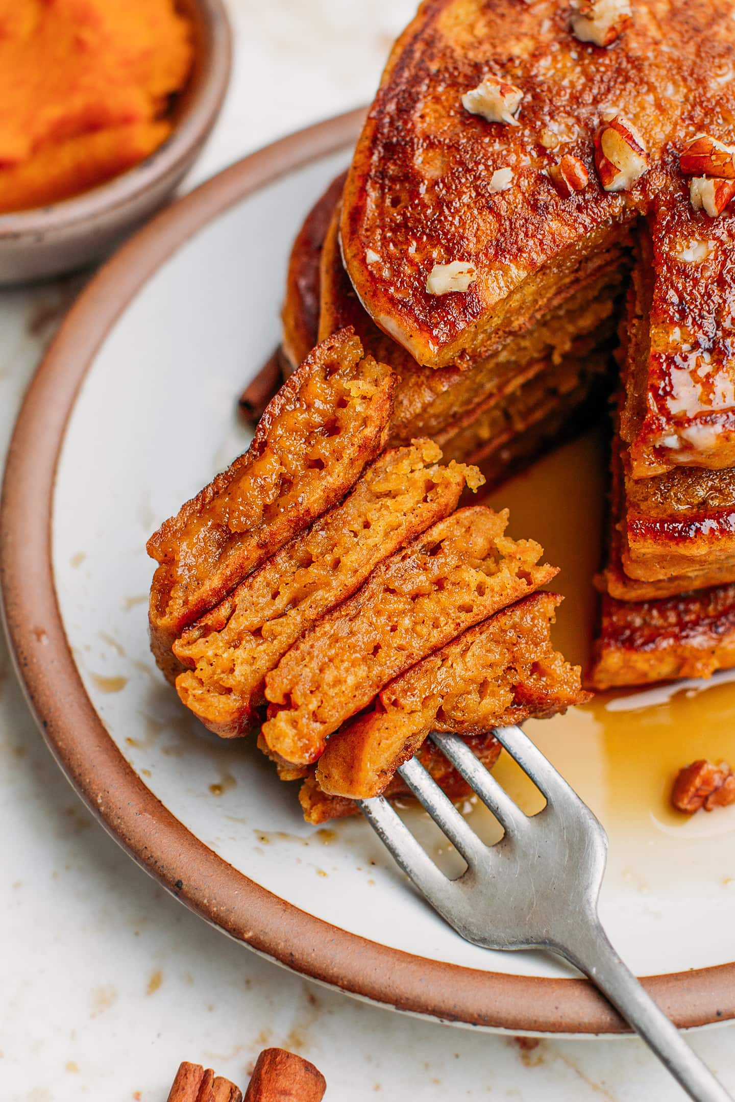 Close-up of a bite of pumpkin pancakes.