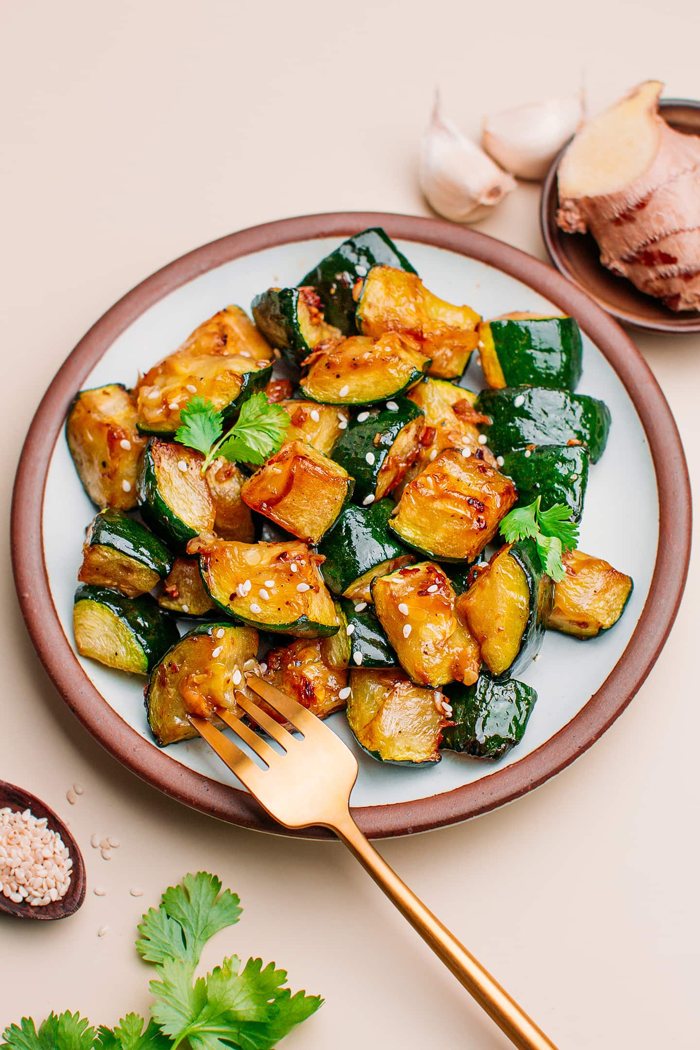 Air fryer zucchini with toasted sesame seeds on a plate.