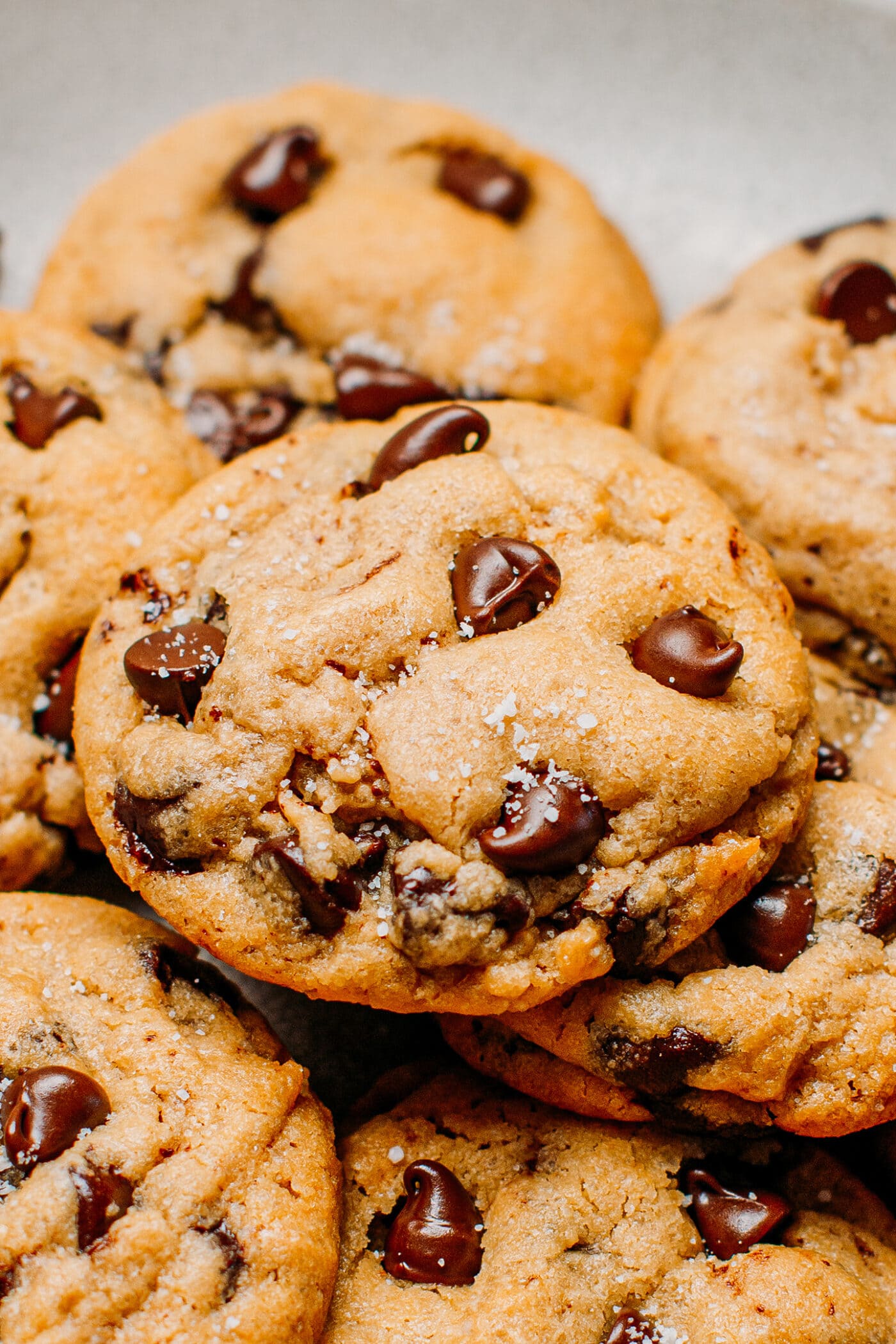 Close up of dark chocolate chip cookies topped with sea salt.