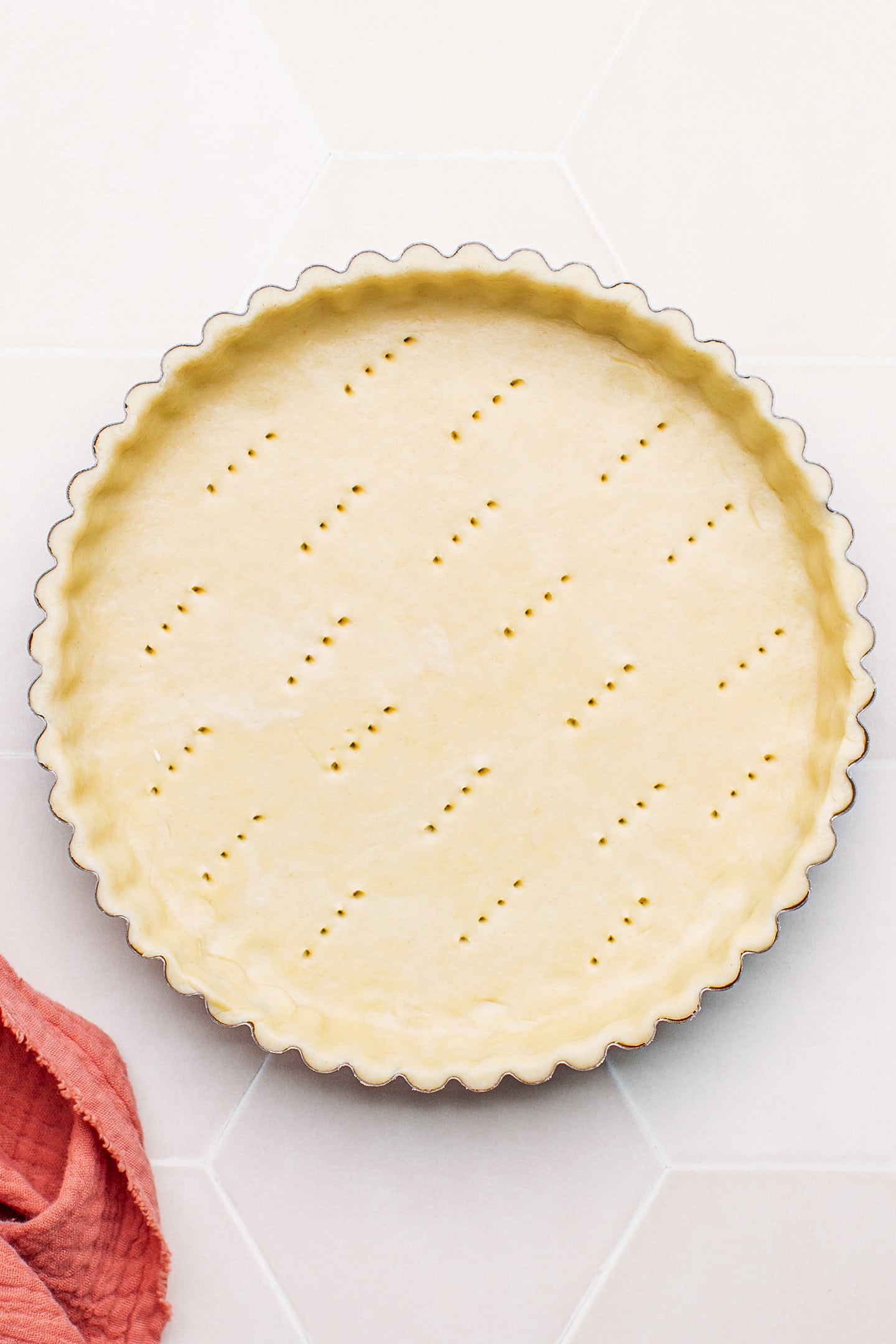 Unbaked pie crust pricked with a fork.