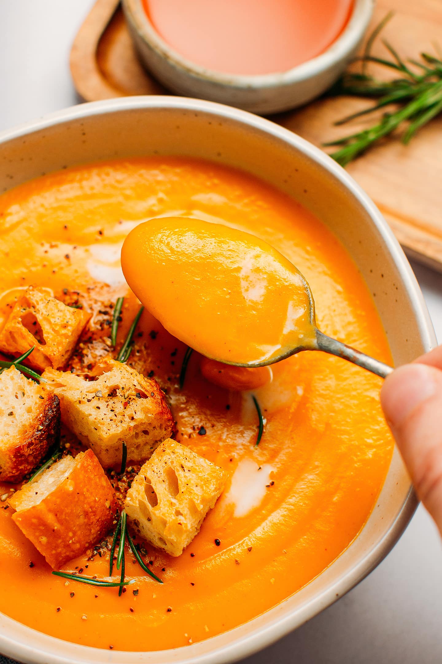 Close up of a spoonful of sweet potato soup.