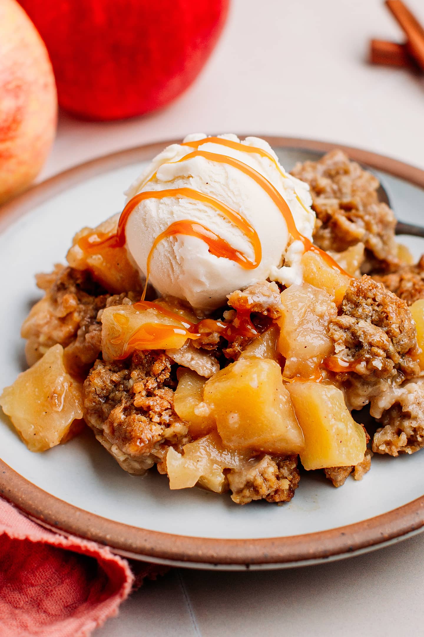 Close-up of vegan apple crisp topped with vanilla ice cream.