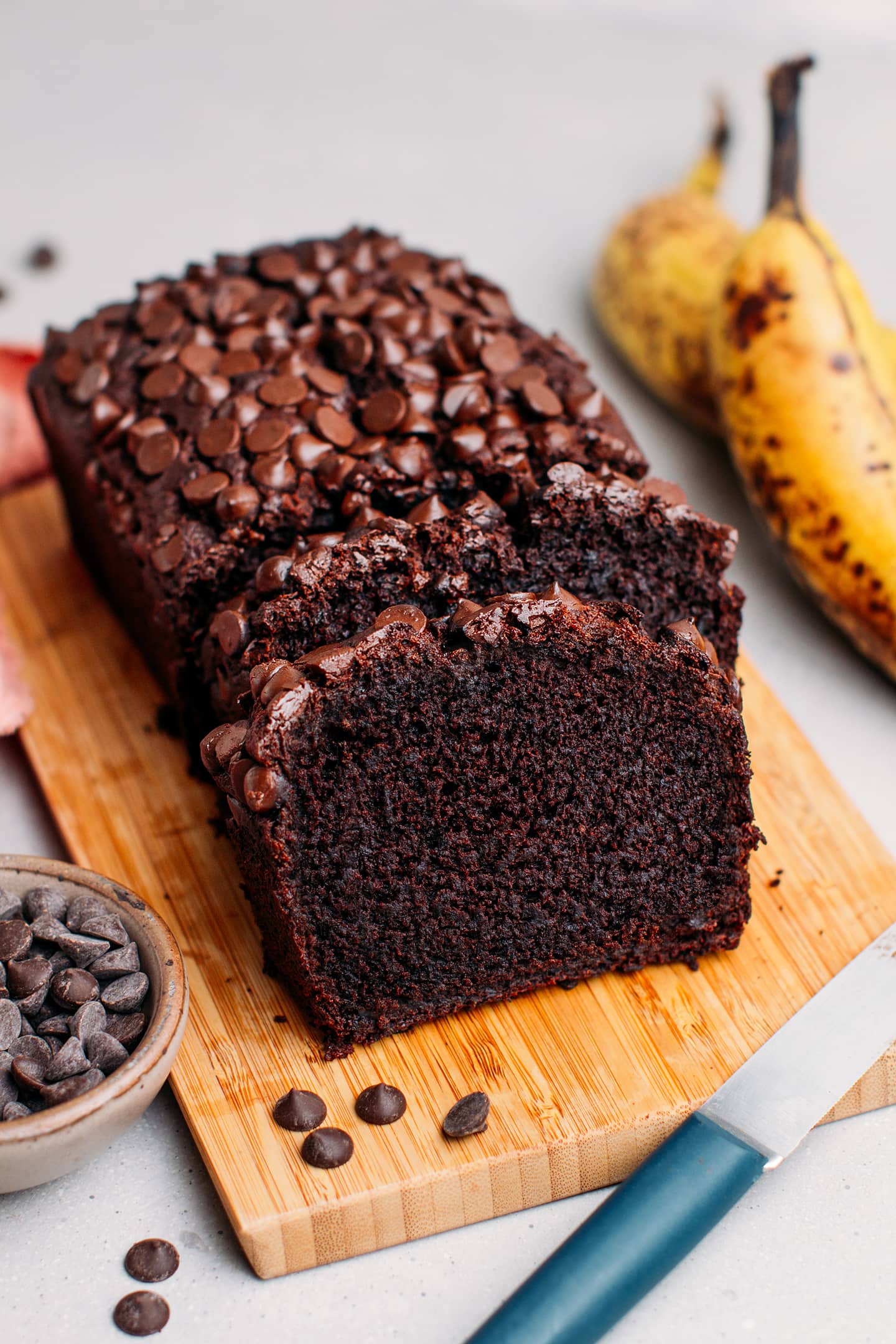 Chocolate banana bread on a wooden cutting board.