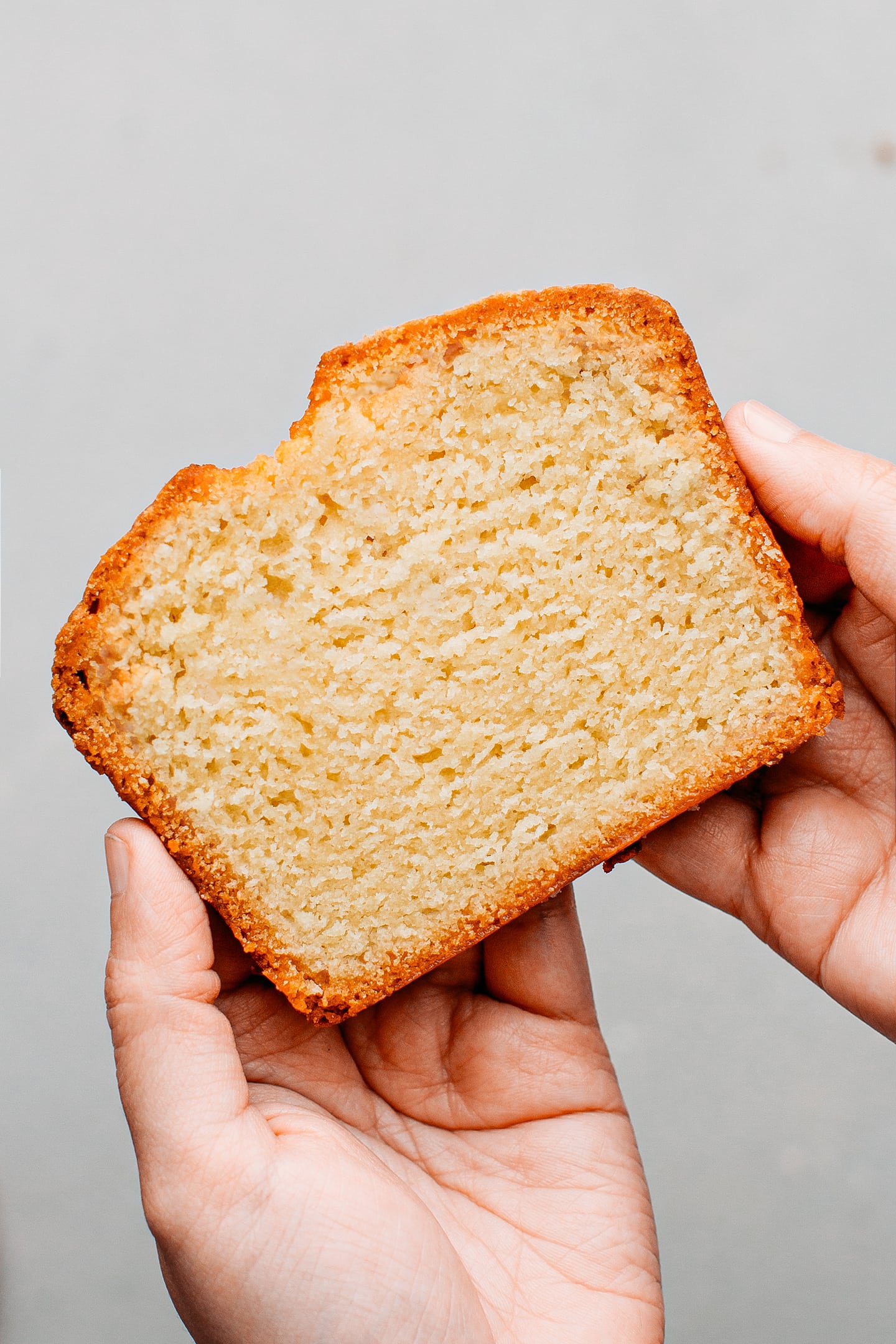 Holding a slice of pound cake.