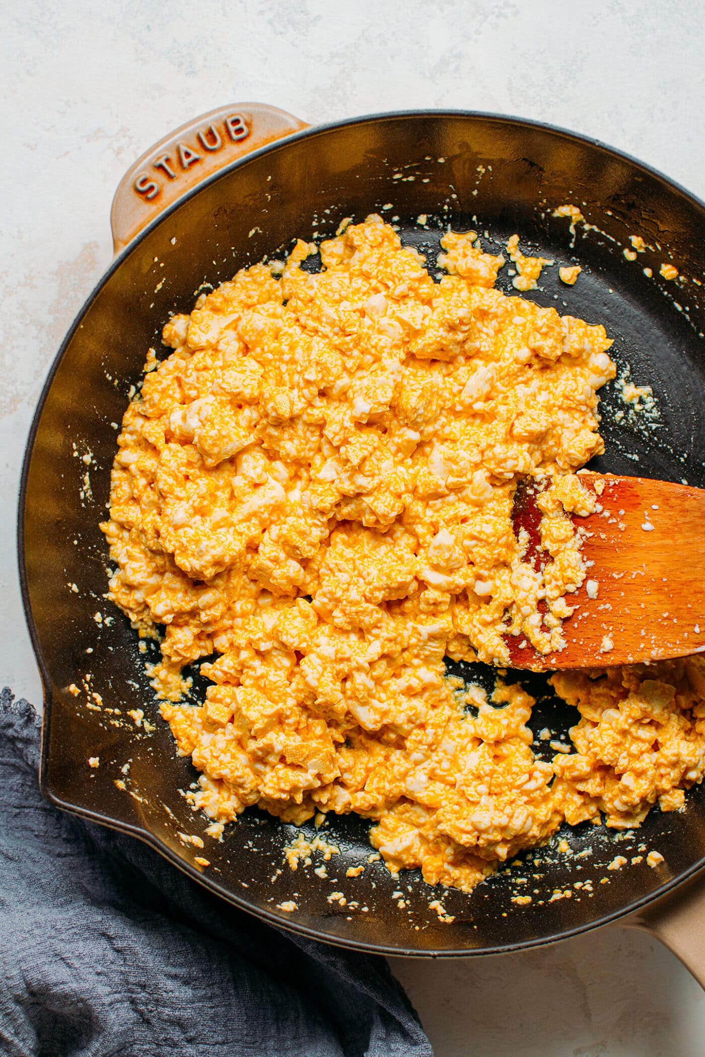 Sautéed silken tofu in a skillet.