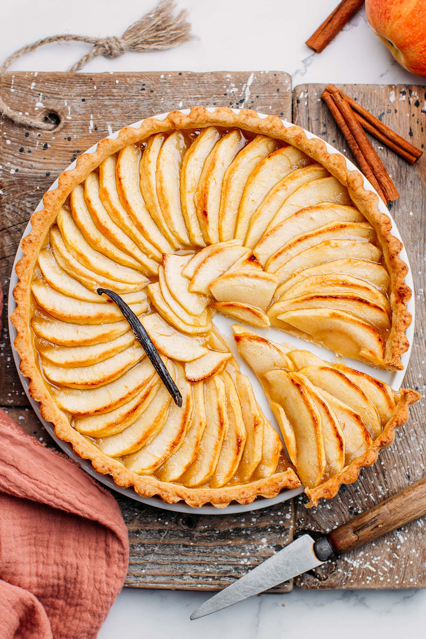 Sliced apple tart with vanilla bean.