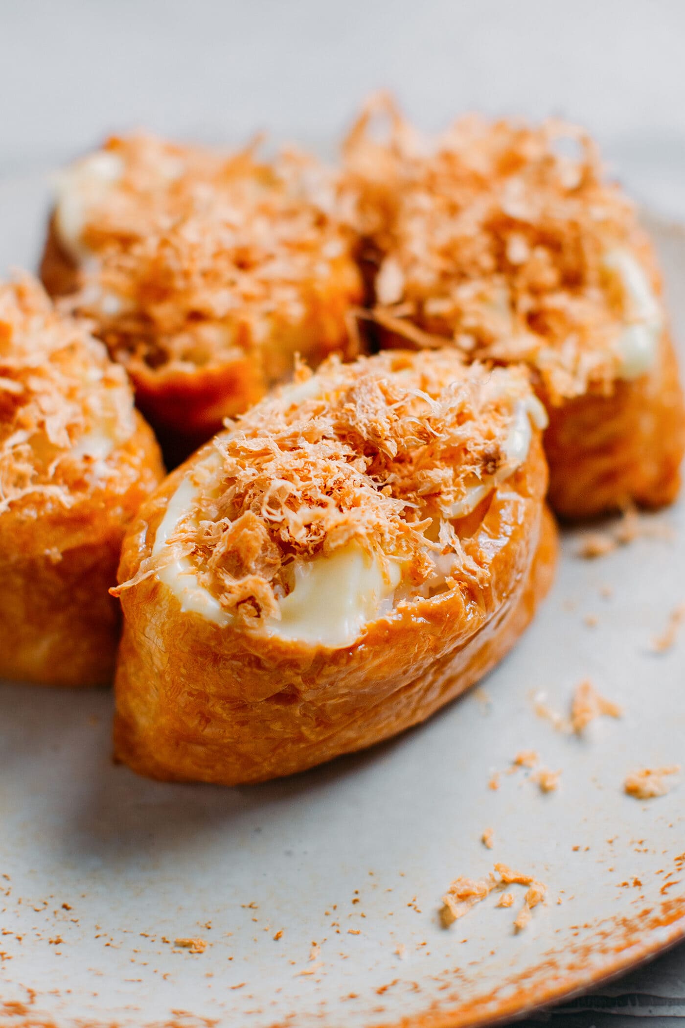 Close up of inari sushi with meat floss and mayo.