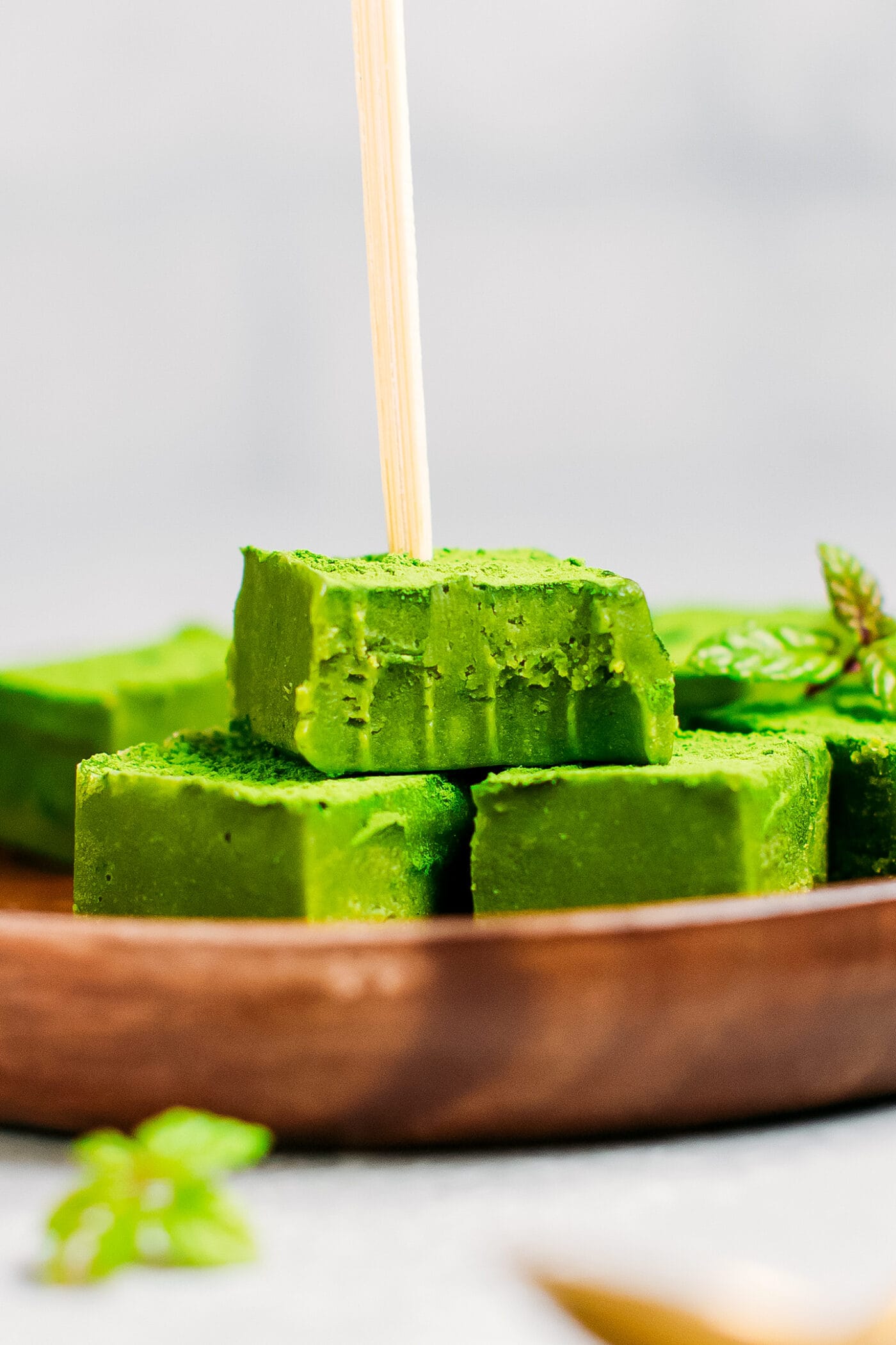 Close up of a bite of matcha nama chocolate.