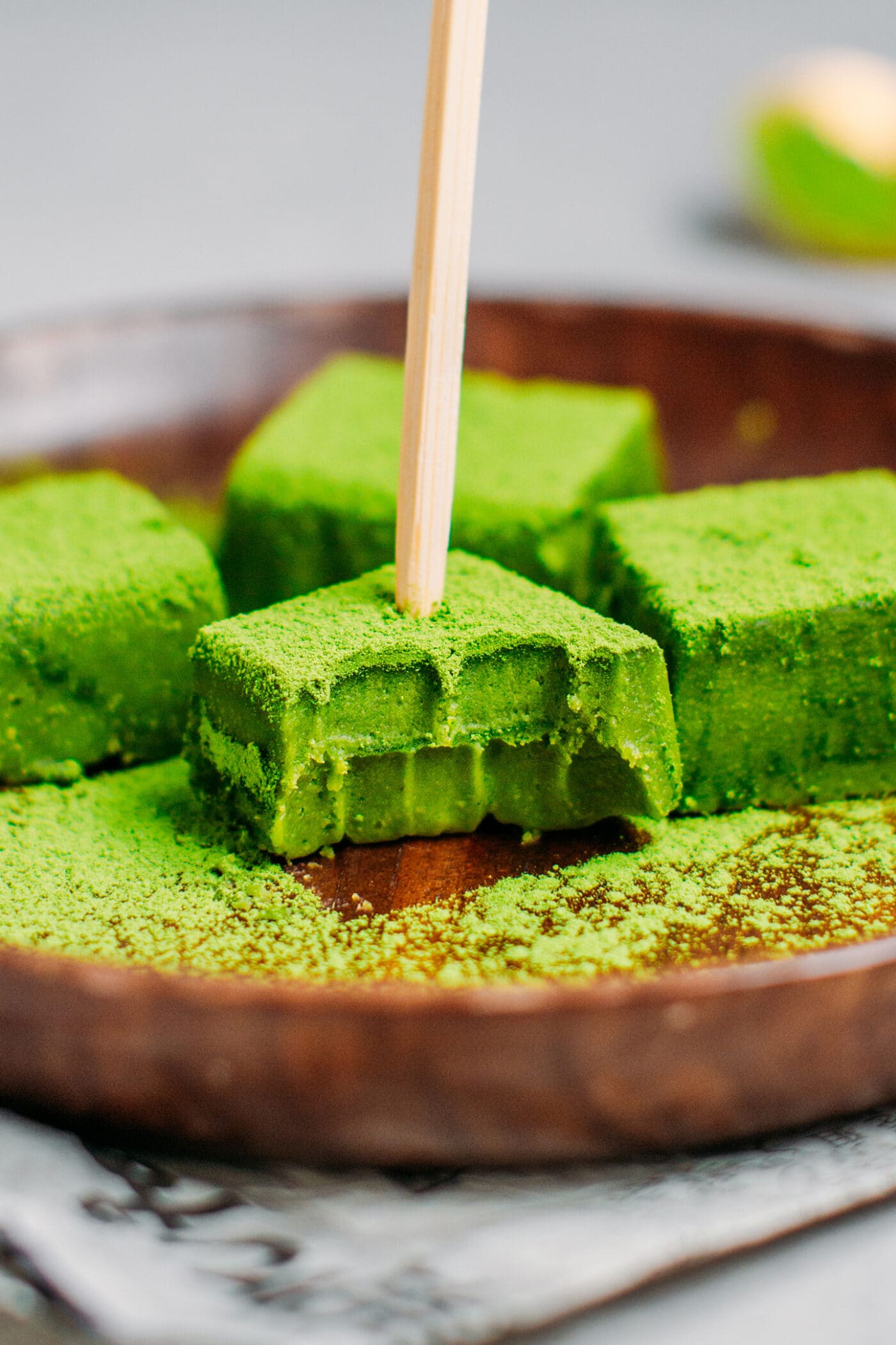 Close up of a bite of matcha nama chocolate.