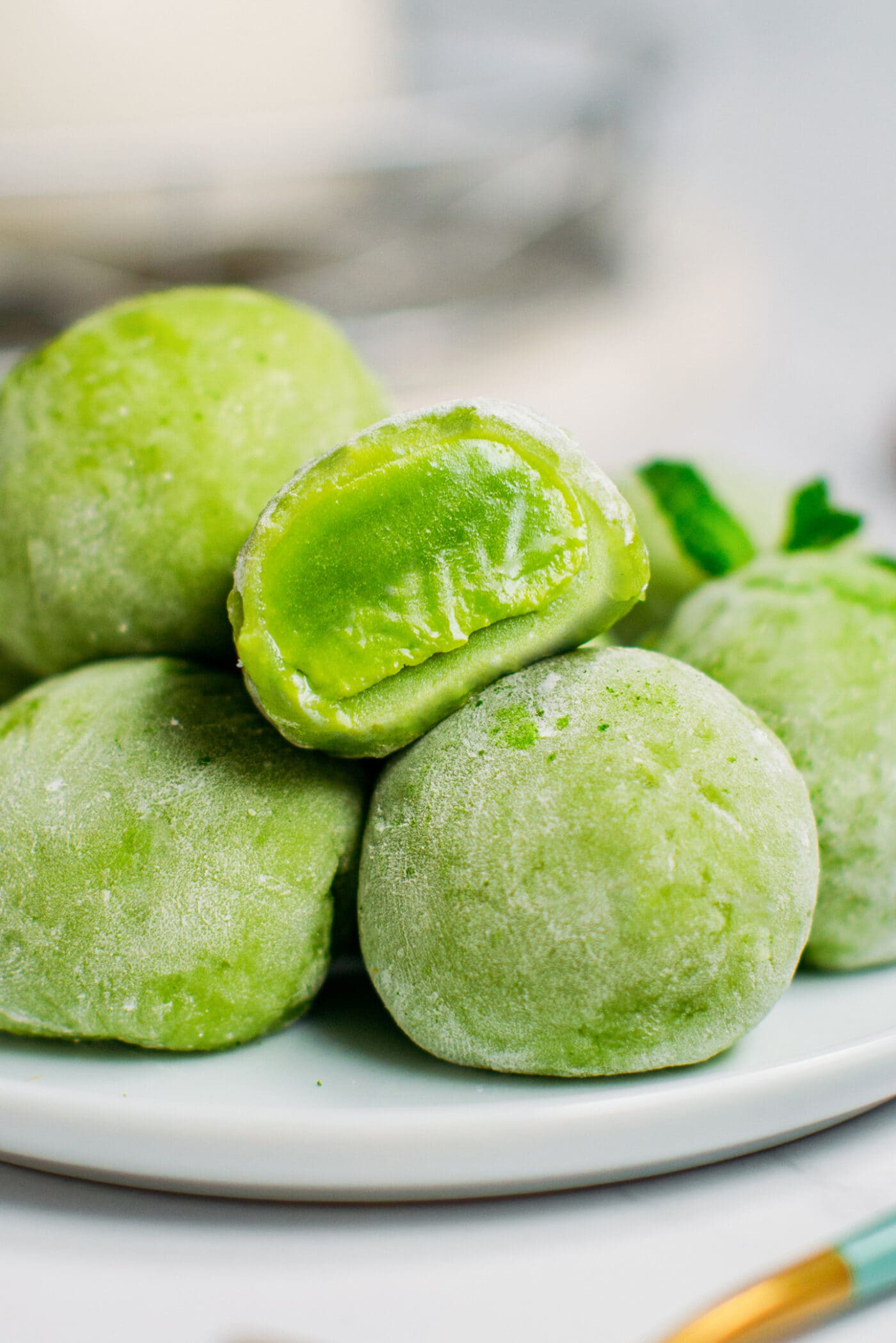 Close up of matcha mochi on a plate.