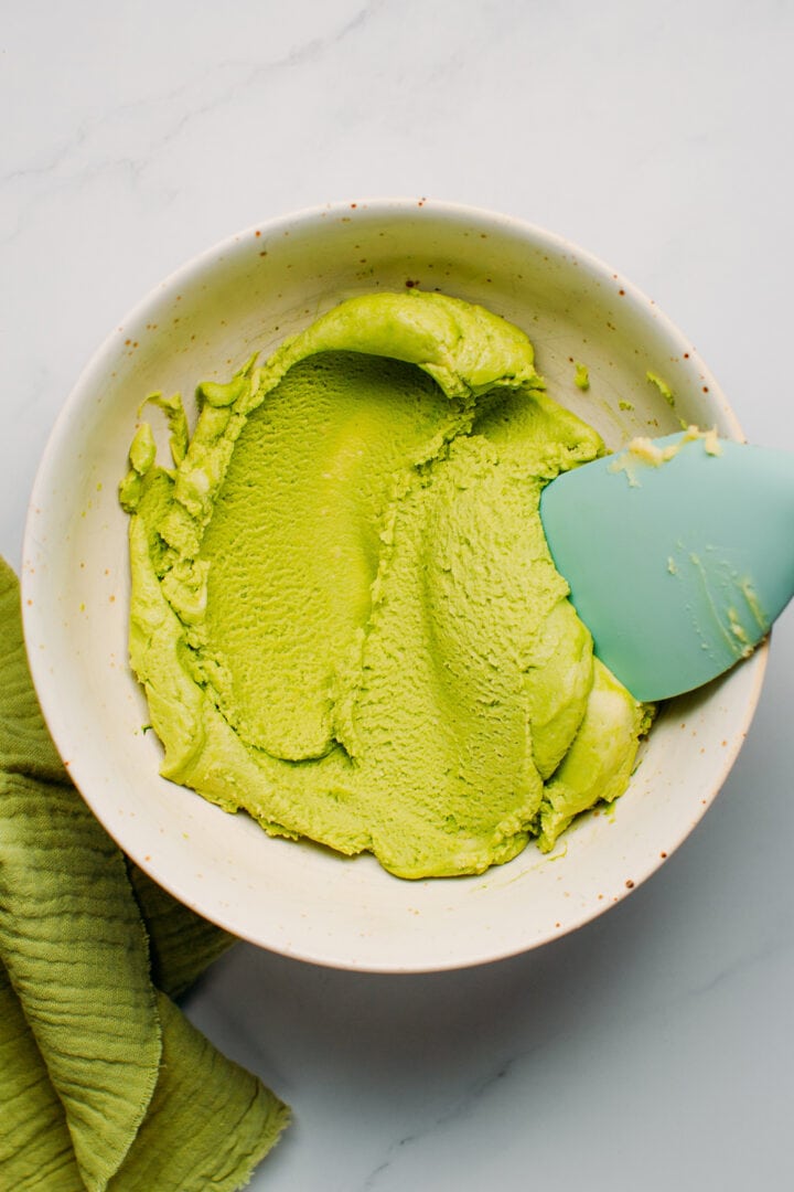 Mixing matcha cookie dough in a bowl.