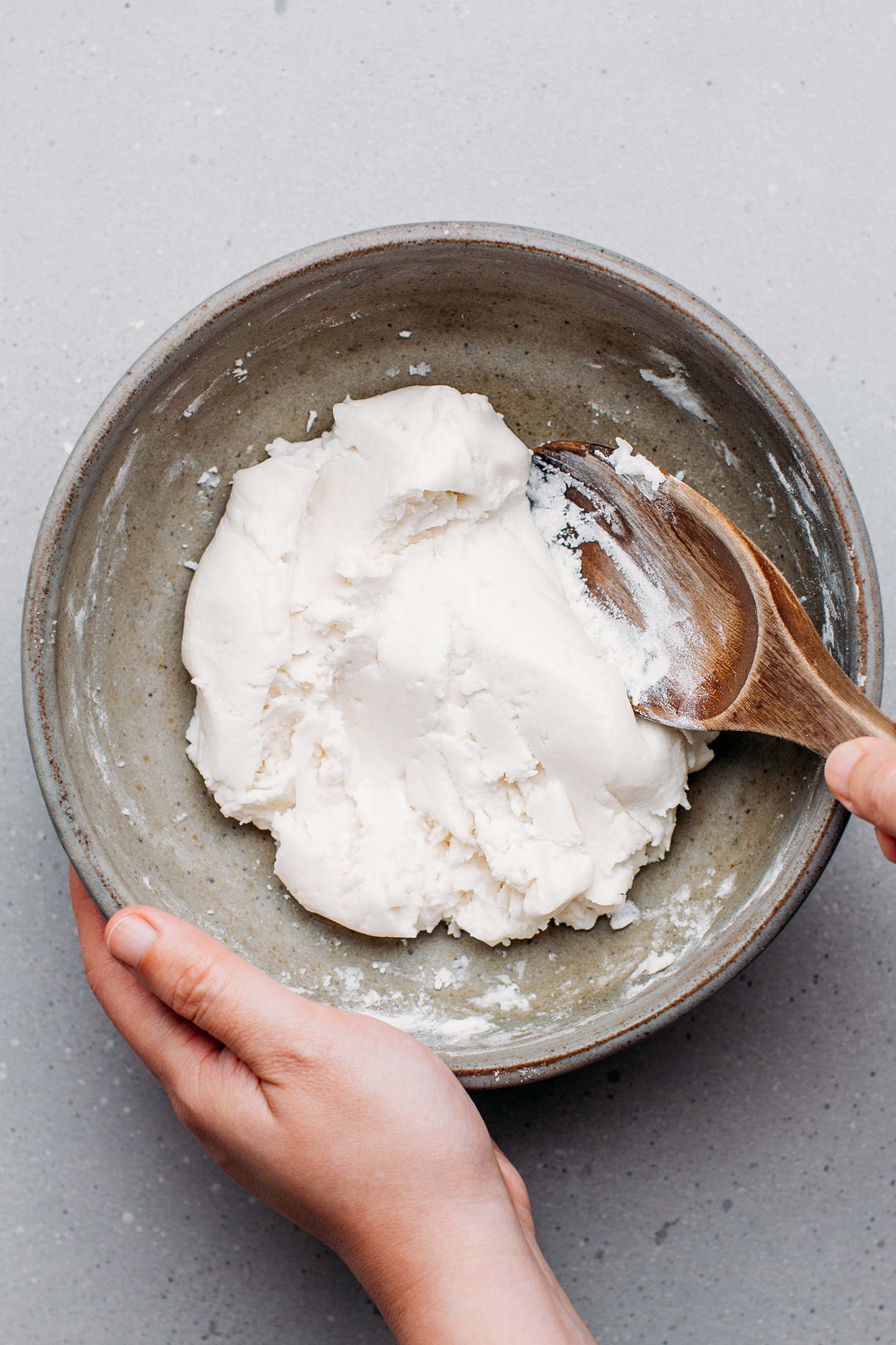 Kneading a dough in a mixing bowl.