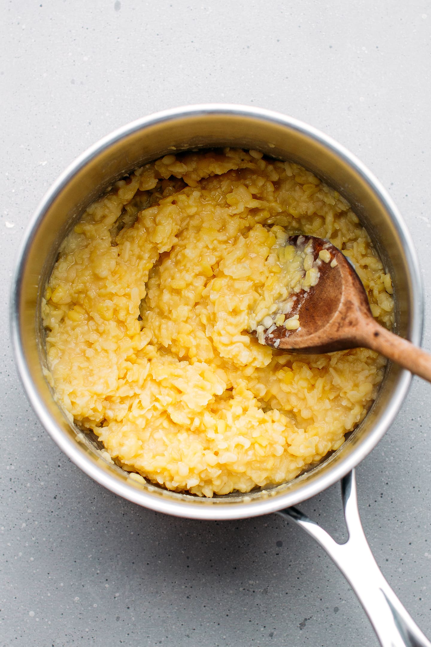 Cooked yellow mung beans in a saucepan.